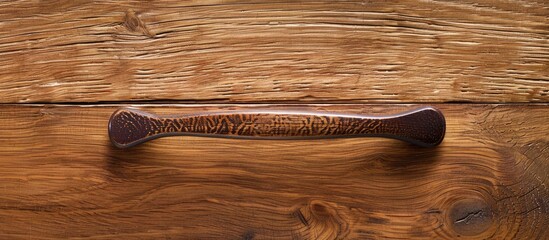 Poster - Close-up image of furniture handle on a wooden texture background with space for copying.