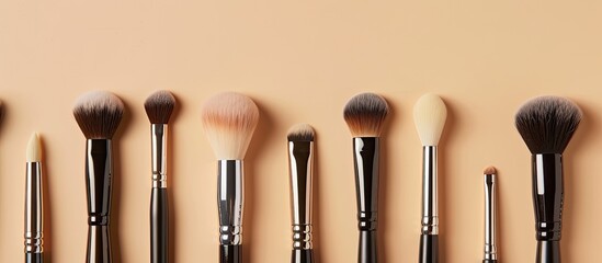 Poster - Close-up of a collection of high-quality makeup brushes displayed on a beige backdrop, providing room for a caption in the copy space image.