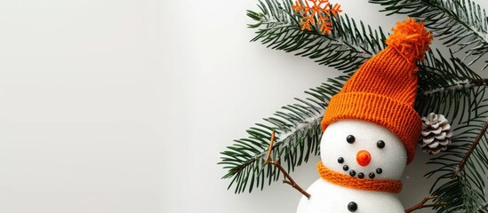 Poster - Copy space image of a handmade snowman with an orange hat and a fir tree branch in isolation.