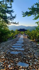 Poster - Stone path leading to a pavilion in a park with trees and mountains in the background