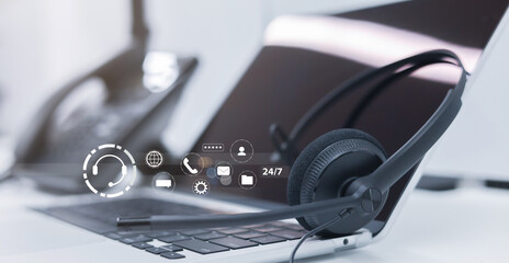 Wall Mural - close up headphone device of call center on table at operation room with virtual icon of symbol telecommunication industry and business technology interface for network engineering concept