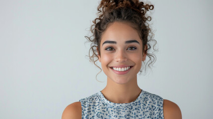 Smiling young woman in casual attire on white background. Ideal for dental care and mental health content.