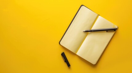 Wall Mural - Notebook with pen on yellow background