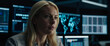 © KII59 - A blonde woman is sitting in front of a computer monitor in a dark room and a blue neon screen with a serious expression on her face. A blonde woman in a digital technology laboratory.
