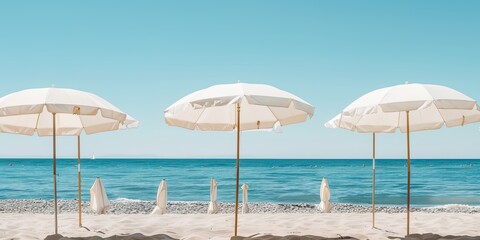 Wall Mural - A beach scene with many white umbrellas on the sand. The umbrellas are arranged in rows, and the beach is empty