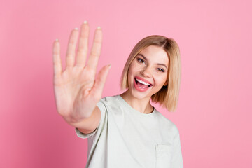 Poster - Portrait of cheerful positive friendly girl with bob hairstyle wear white t-shirt give you highfive isolated on pink color background