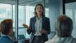 © PNGPlanet - A businesswoman presenting to a group in a meeting room with a suitcase in the background, indicating business travel.