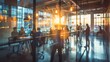 © nuttapong - Silhouettes of people in a modern office space with large windows and warm lighting.