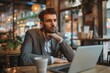 © ORG - Careful businessman working with laptop in cafe