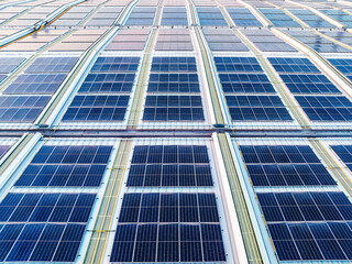 Canvas Print - Solar panels on factory roof. Green energy technology background