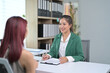 © Parichat - Professional Businesswoman Conducting Interview in Modern Office Setting
