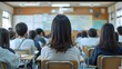 © naphat - Photo of high school students taking an exam in a classroom, with whiteboards and blackboards in the background. The scene depicts a Japanese high school. Taken from the front view, with blurred
