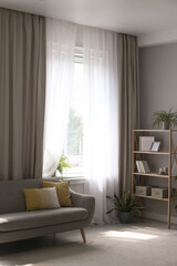 Canvas Print - Comfortable sofa and elegant curtains in living room. Interior design