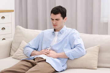 Canvas Print - Man suffering from abdominal pain at home