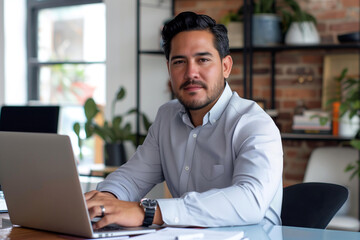 hispanic entrepreneur, manager or businessman work on his laptop in his office, embodies professiona