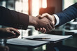© Kakabe - Businessmen shaking hands over a contract, symbolizing partnership, agreement, and successful business negotiation in a professional setting.