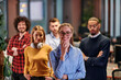 © .shock - Portrait of successful creative business team looking at camera and smiling. Diverse business people standing together at startup. Selective focus