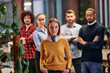 © .shock - Portrait of successful creative business team looking at camera and smiling. Diverse business people standing together at startup. Selective focus