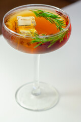 Canvas Print - A glass of cocktail with a garnish of rosemary on top