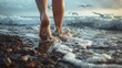 © fivan - Bare feet walking along a rocky shore, with waves crashing nearby and seagulls in the distance