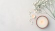© K-MookPan - Minimalist spa setting with candles and white flowers.