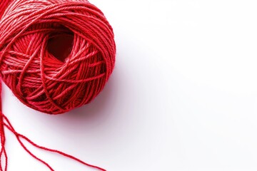 Aufkleber - A small red ball of yarn sitting on a white background, perfect for craft or design projects