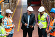 © bulentbaris - Effective Management in Action: Businessman Engaging and walking with Warehouse Worker and Engineer, Utilizing Digital Tablet