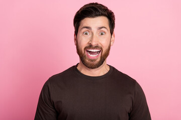 Wall Mural - Photo of overjoyed man with stubble brunet hair dressed brown t-shirt astonished staring open mouth isolated on pink color background