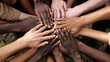 © XaMaps - A close-up of a diverse group of hands joined together, symbolizing unity and friendship.