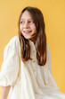 © Melissa Milis Photography/Stocksy - Girl in soft yellow dress portrait
