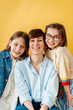 © Melissa Milis Photography/Stocksy - Stylish family studio portrait over yellow backdrop