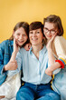 © Melissa Milis Photography/Stocksy - Portrait of mother with confident daughters