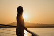 © Heng Yu/Stocksy - Woman Enjoying Sunset by the Water