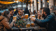 © Karo - A group of happy friends a drinking beer together at a street cafe.