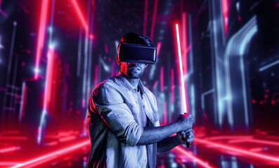 Wall Mural - Gamer holding laser sword and playing action game while wearing VR glasses. Caucasian man using visual reality headset while standing and surrounding by neon castle. Innovation technology. Deviation.
