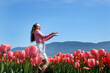 © Oleksandra - Attractive woman in a nice flowery dress walking through endless tulips field in spring. Aerial view of colorful tulips in bloom and girl. Concept: Tulips in Keukenhof gardens, Netherlands, Holland.