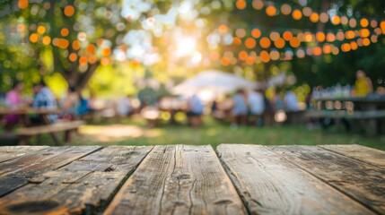 A rustic wooden table set at an outdoor gathering with glowing string lights and blurred figures in the background, evoking a warm, festive, and communal atmosphere.