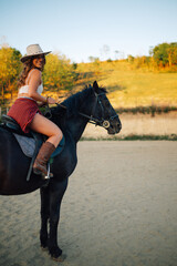 Wall Mural - Cropped picture of rider in western outfit horseback riding at ranch.