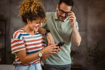 Wall Mural - adult couple husband and wife enjoy and use mobile phone together