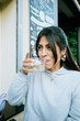 © Mal de Ojo Studio/Stocksy - Young Woman Enjoying Drink in Town