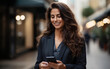© imagineRbc - A young woman in a black blazer smiles while using her smartphone on a city street