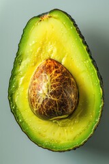 Poster - Fresh avocado cut in half on a table, ready for use or display