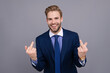 © be free - Businessman in suit shows an indecent gesture isolated on grey. Arrogant lawyer man with middle finger. Business man show offensive gesture. Body language. Rude businessman show middle finger