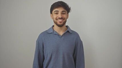 Poster - Happy, young arab man standing confidently, exuding positivity with a toothy smile, looking upbeat over an isolated white background