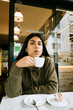 © Mal de Ojo Studio/Stocksy - Young Woman Enjoying Coffee in Milan