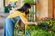 © Iryna Shepetko/Stocksy - Woman buying flowers
