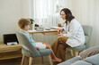 © Duet Postscriptum/Stocksy - Female pediatrician questions a young boy about his medical condition