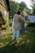 © AD Astra Team/Stocksy - Woman making laundry at the backyard countryside