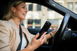 © DZ FILM/Stocksy - A woman is driving a car