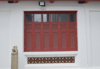 Canvas Print - wooden window on cement wall